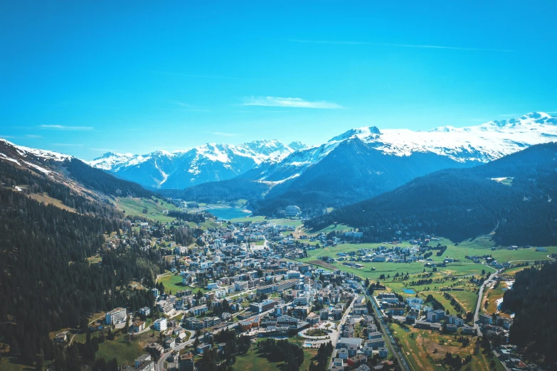 a town in the middle of mountains surrounded by snow