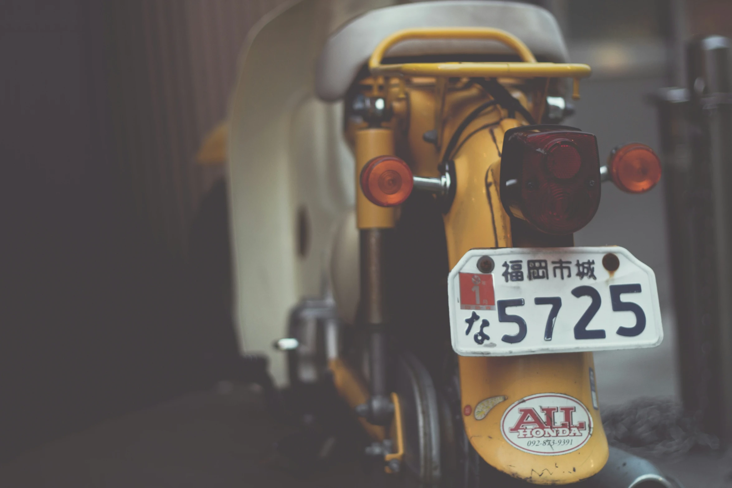 a close up of a bike with a license plate