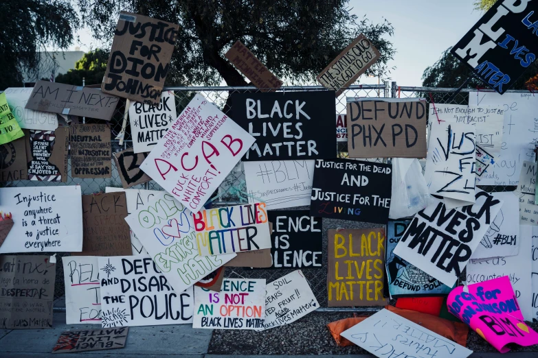 many political signs are on display against a wall