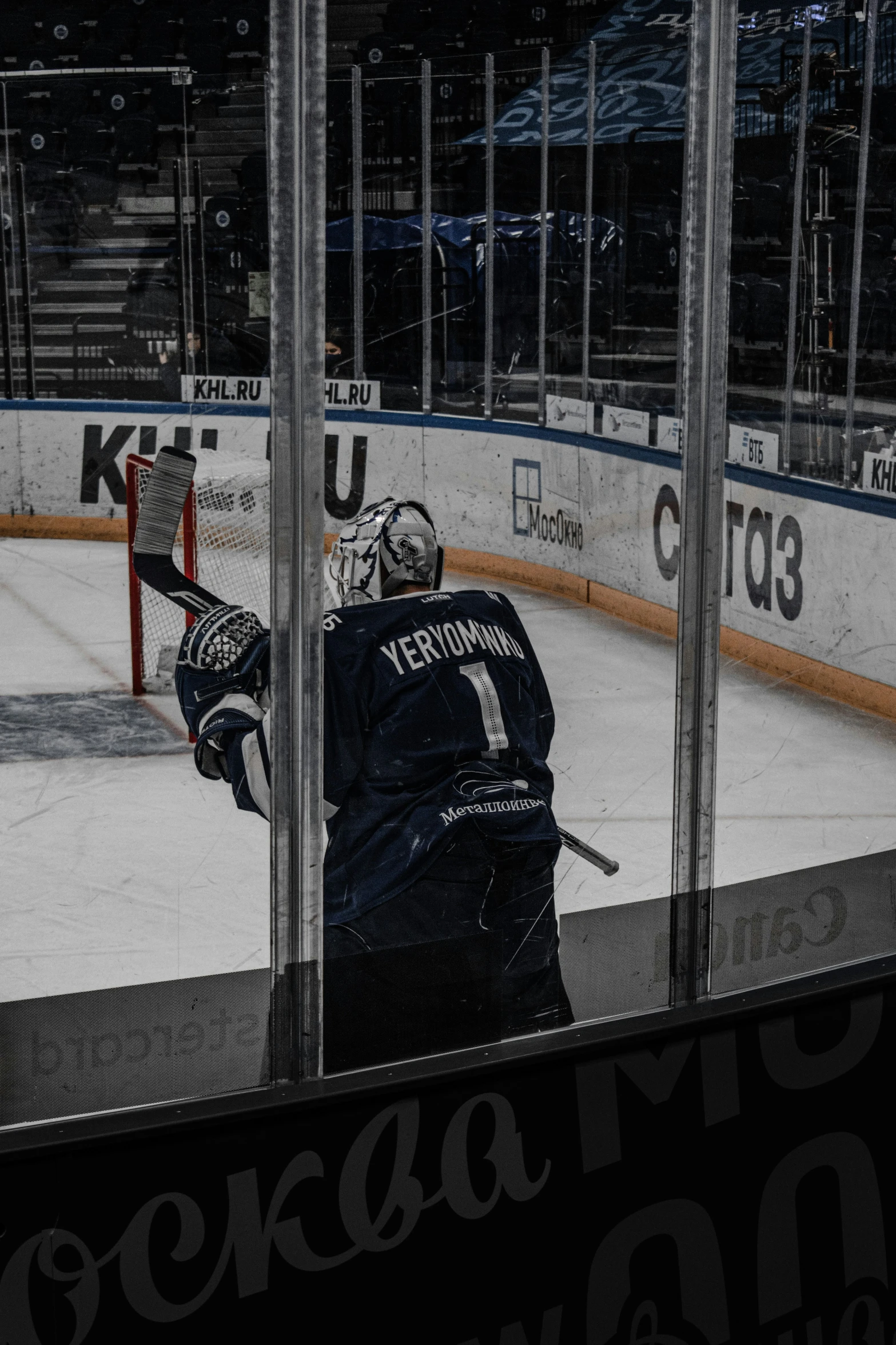 a hockey goalie getting into position to hit a ball