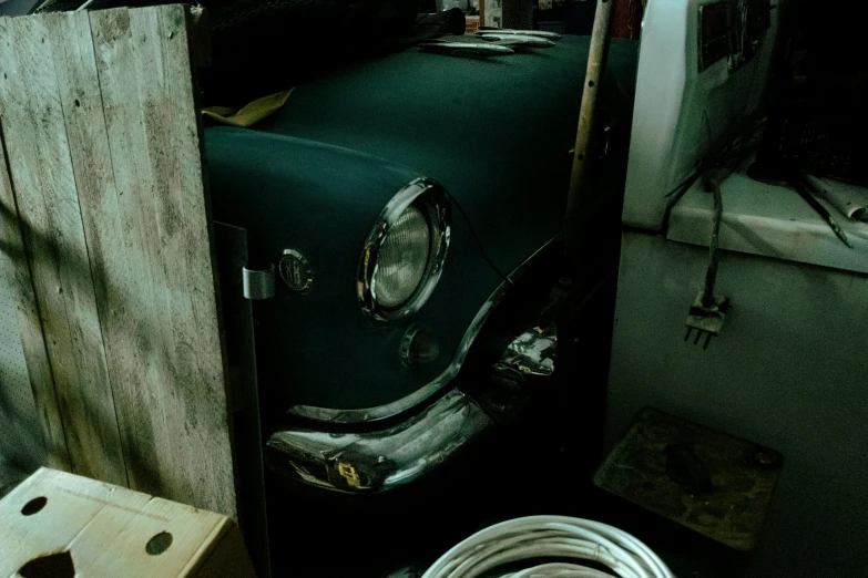 the old car is parked behind some wooden boards