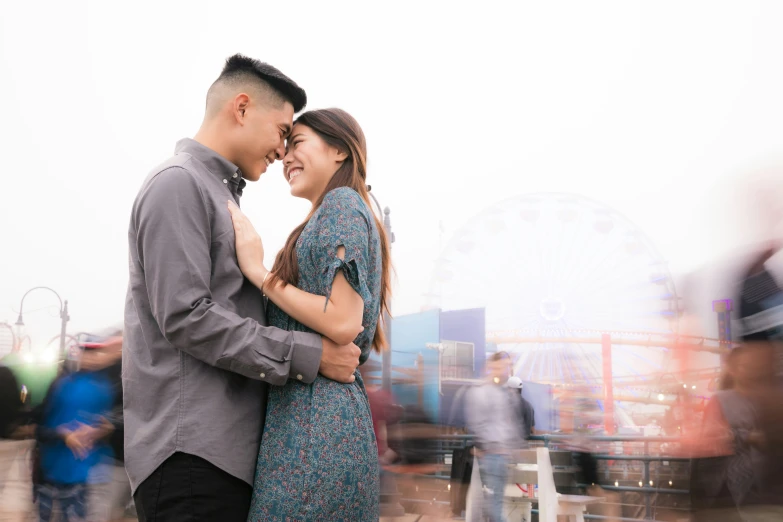 a young couple holding each other close to their forehead