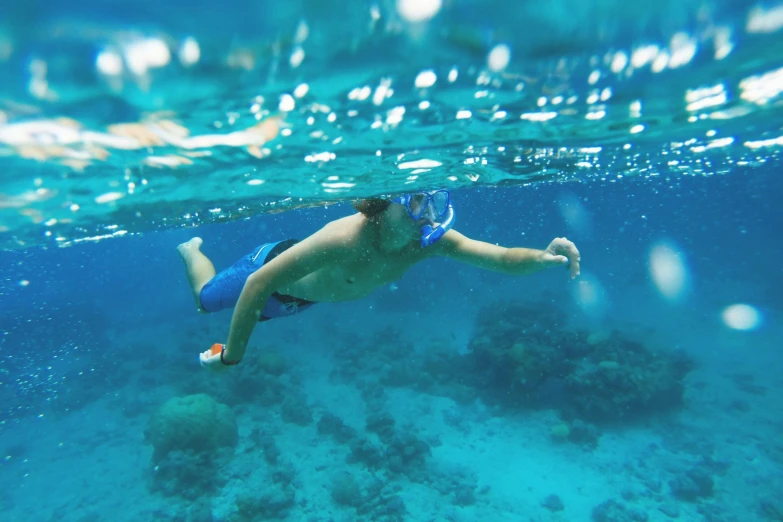 a man swimming through the water in the ocean