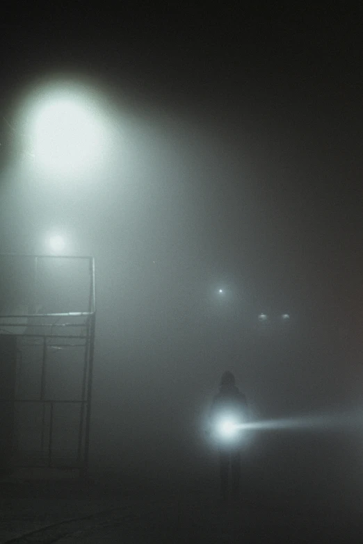 an empty bus stop and a chair in the fog