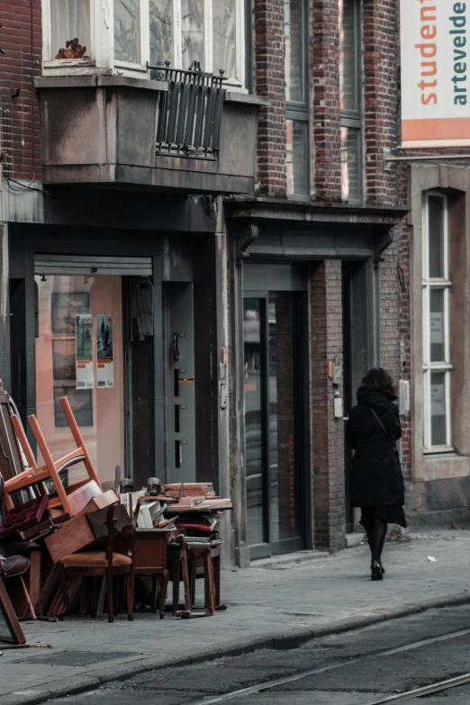 a street corner with an upturned chair and chair on the sidewalk