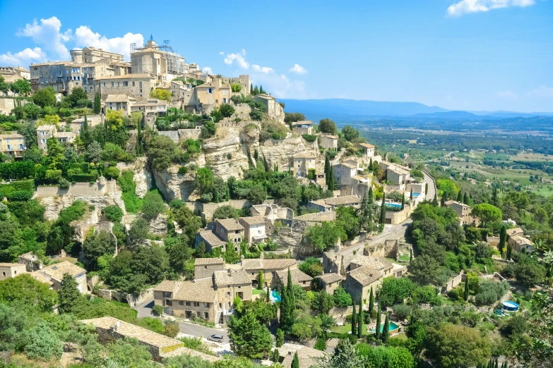 an old stone city is shown near the water