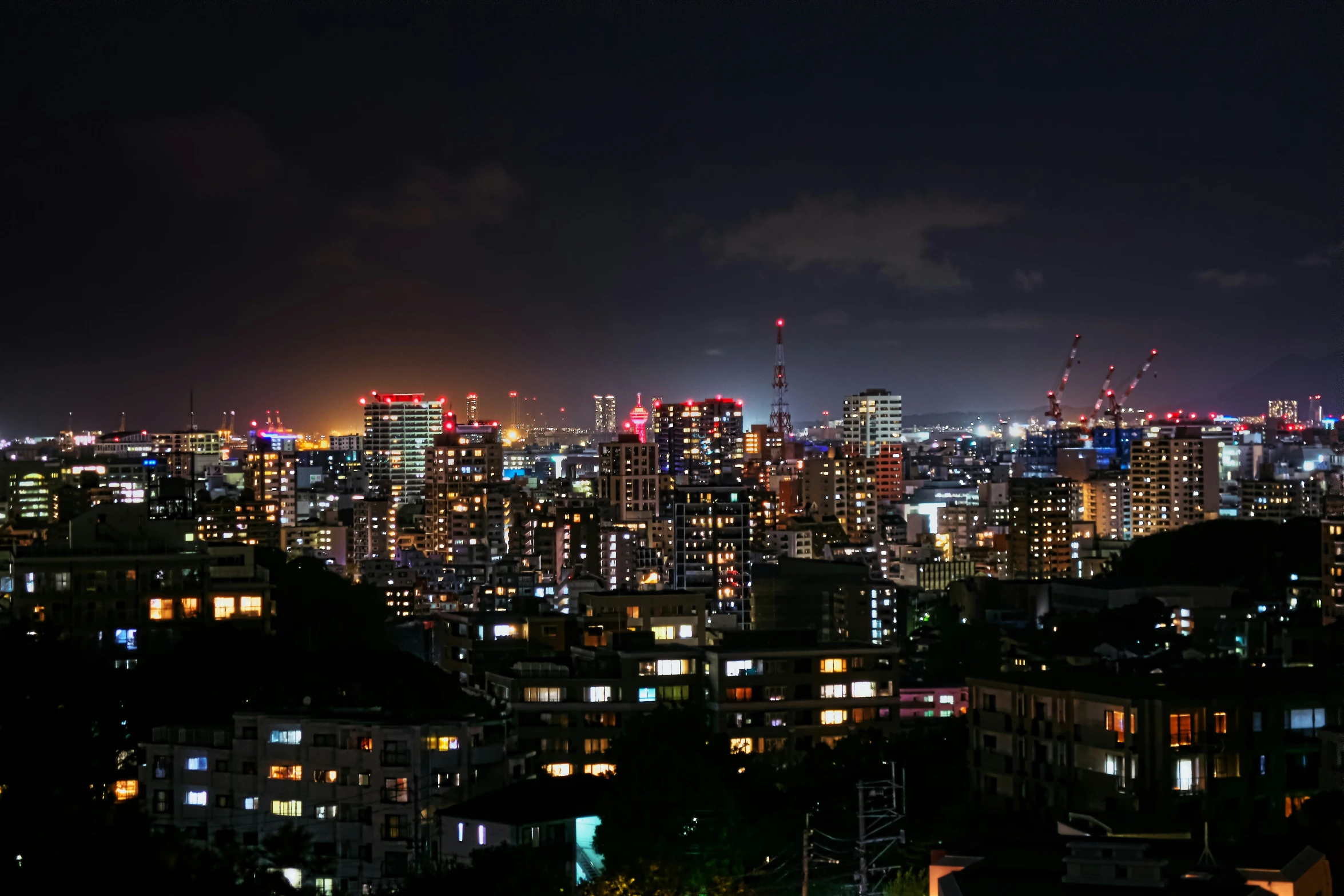 a view of a city from a rooftop at night