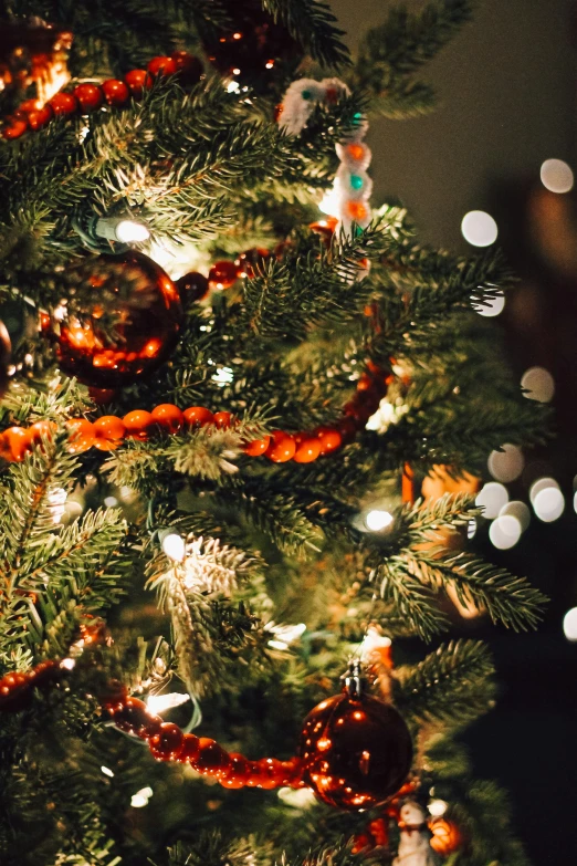 a close up po of a christmas tree with lights