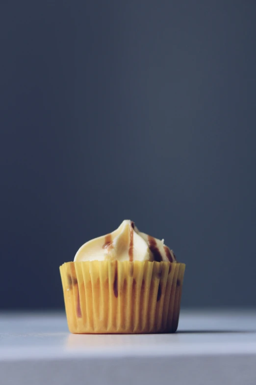 there is a cupcake with chocolate and icing on it