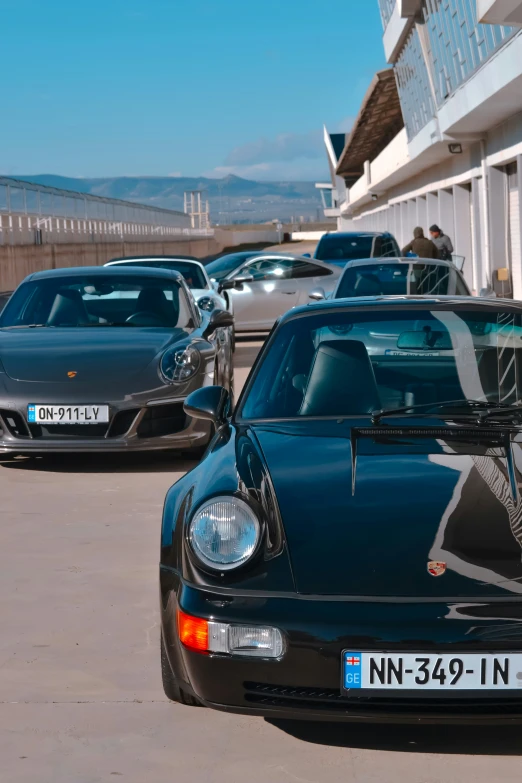 some very pretty cars parked in front of a building