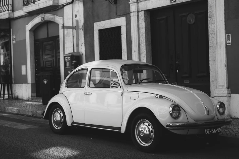 a vintage volkswagen parked in front of a building