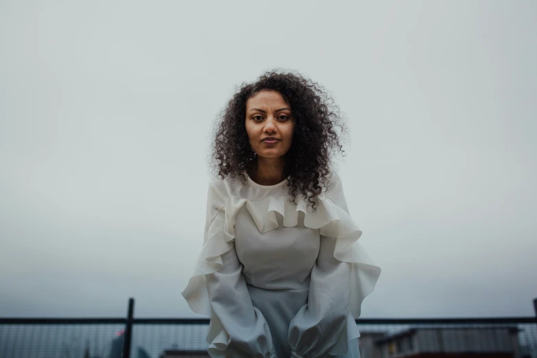 a woman is standing in the middle of a group