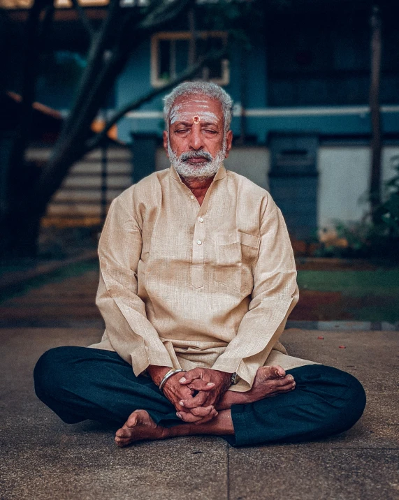 the man is doing yoga outside on the sidewalk