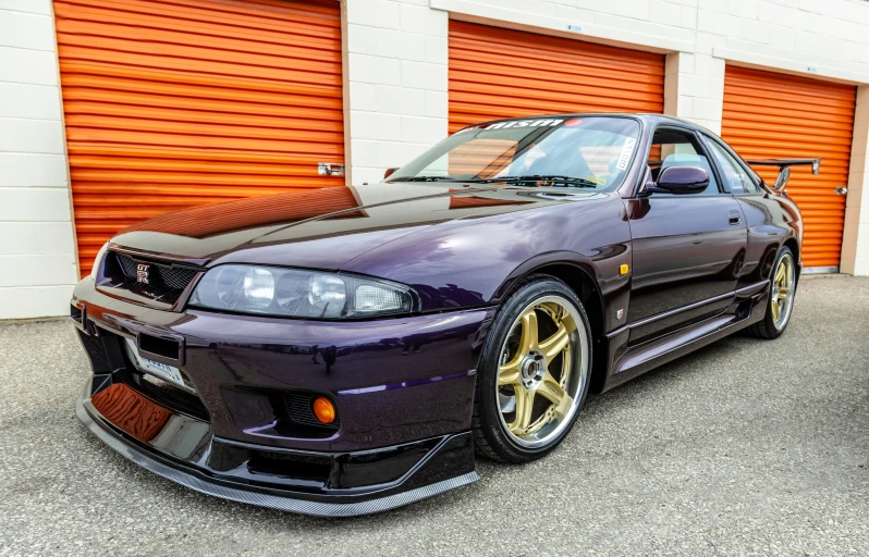 this car is painted purple with gold rims