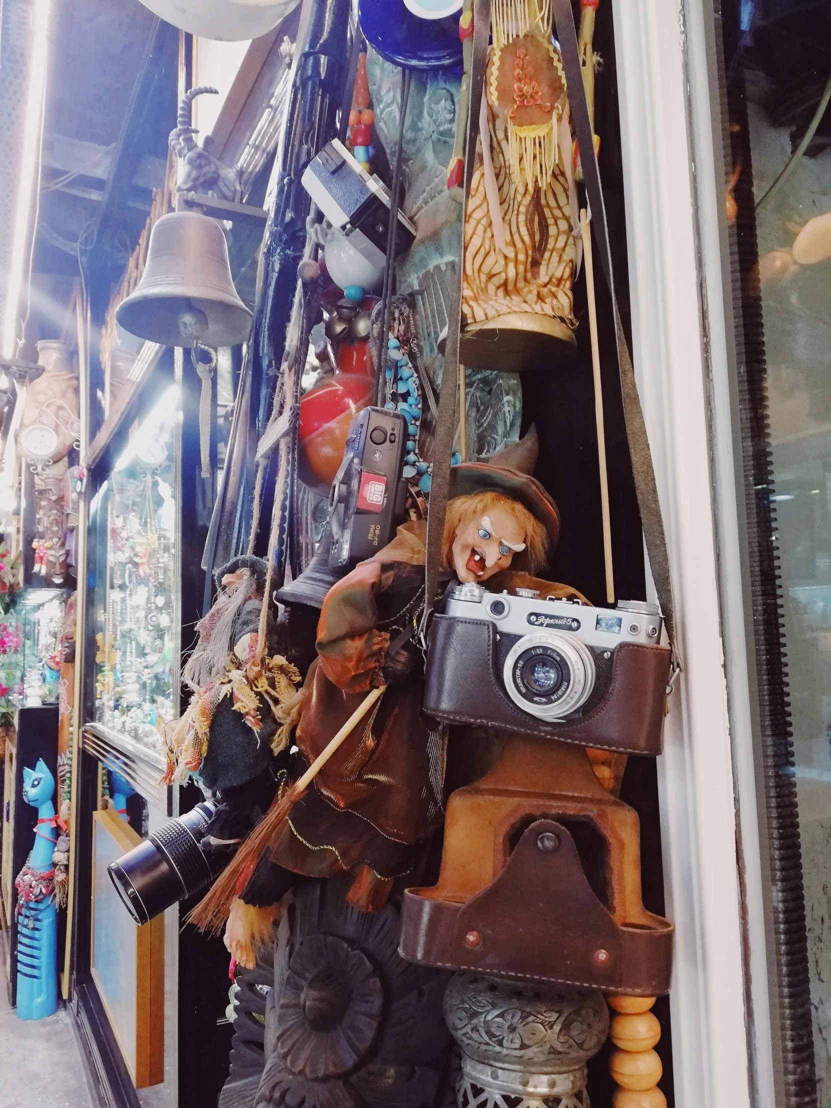 a collection of handmade hats and masks on display outside of a store