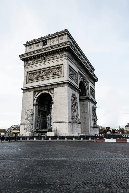 the arc of triumph in paris is pictured on a cloudy day