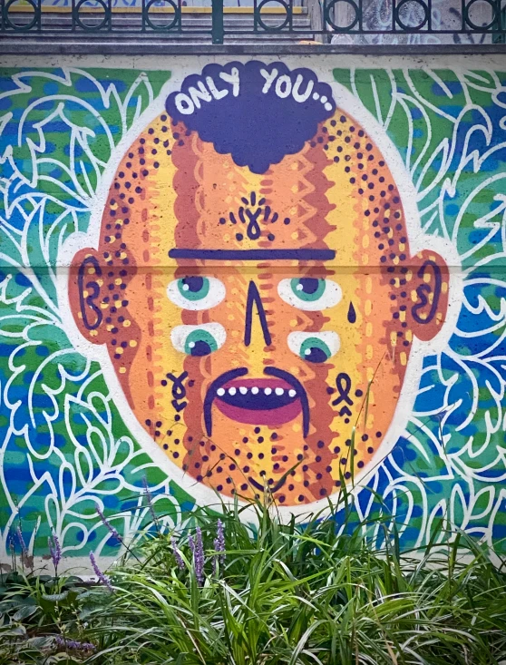 graffiti with a painting of a man's face in the center