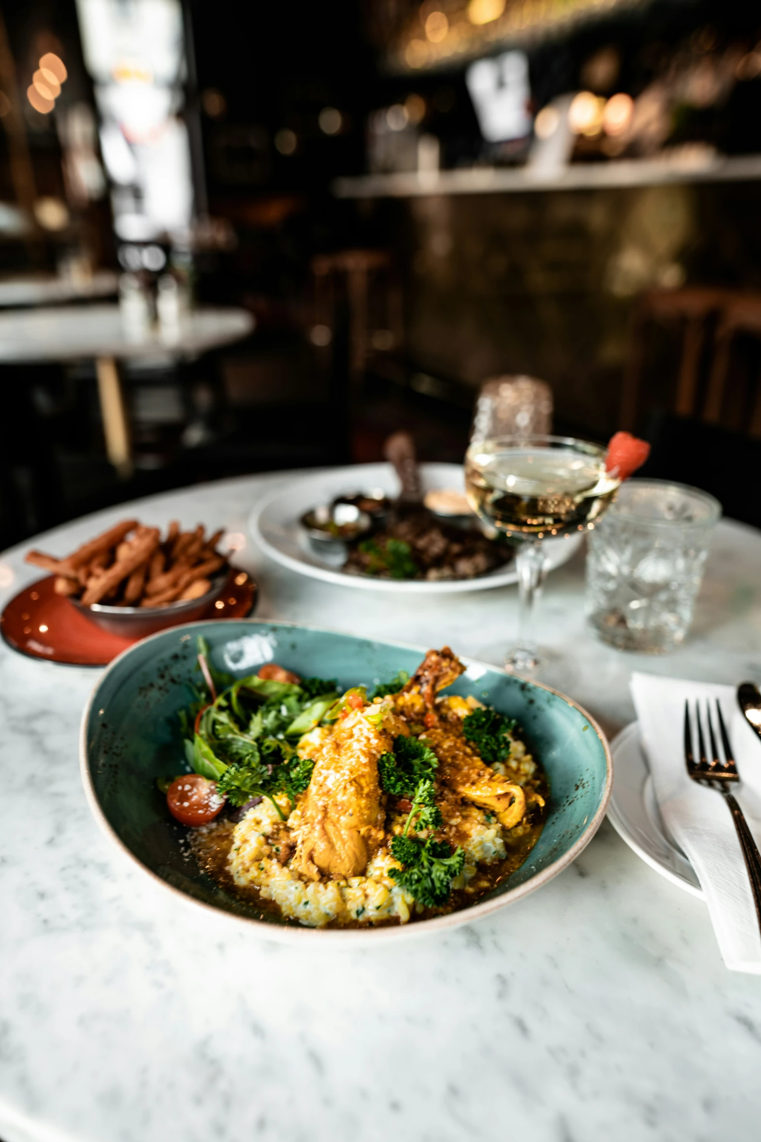 a white table topped with plates of food