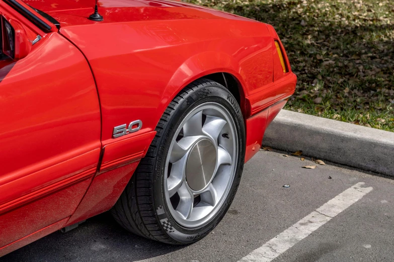 a red sports car that has had its tire change