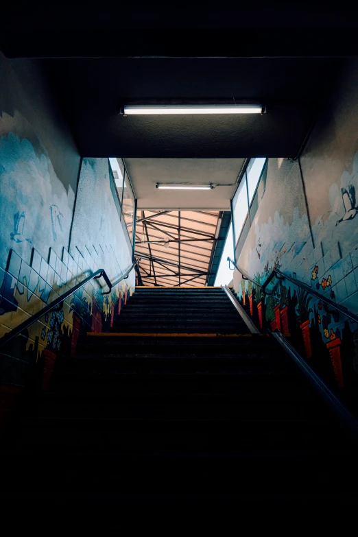 a long staircase with graffiti on the walls