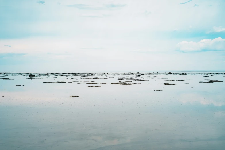 some water is on the beach with low clouds