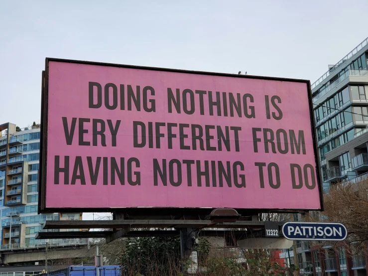 a large pink billboard with a quote from pat patron on it