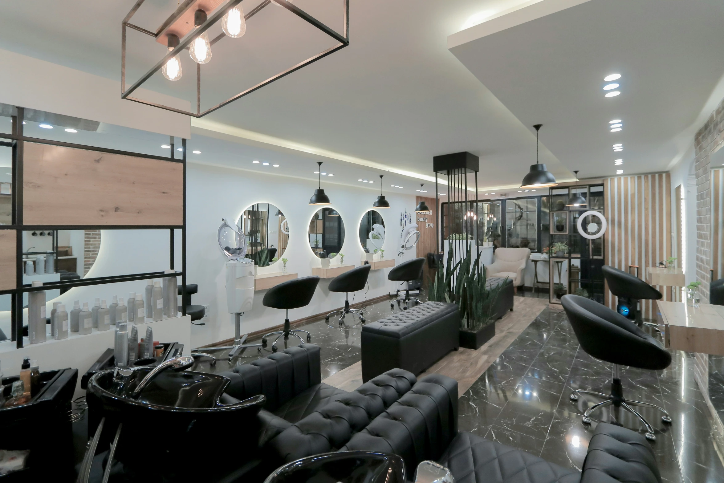 a group of black chairs inside of a hair salon