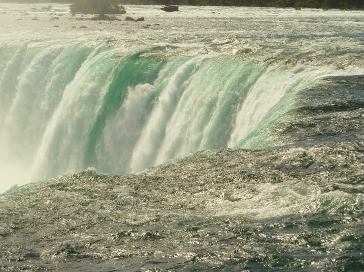 the water pours into the side of a waterfall