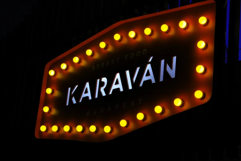 a street sign has been illuminated by several yellow lights