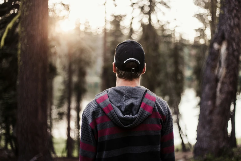 a man wearing a cap in the woods