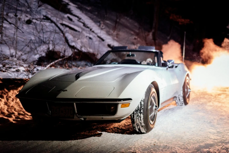 a large white sports car kicking up smoke in the snow