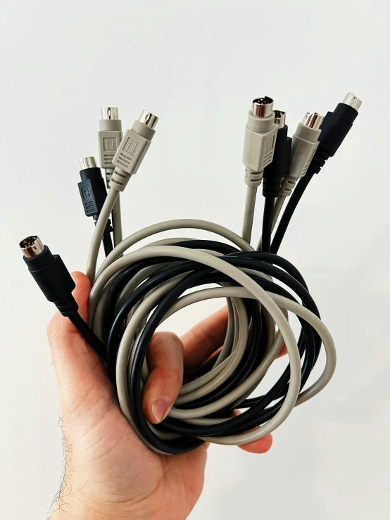 a person holding some wires and cords