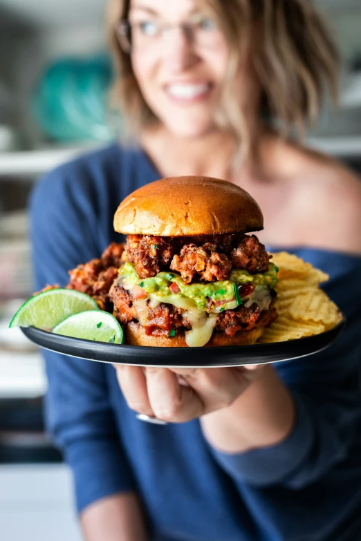 a person holding a plate full of food