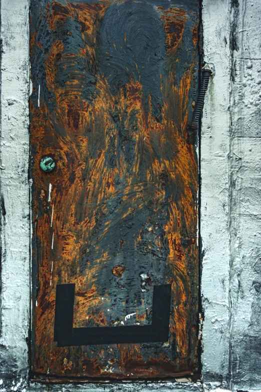 a rusted metal wall and door on a building