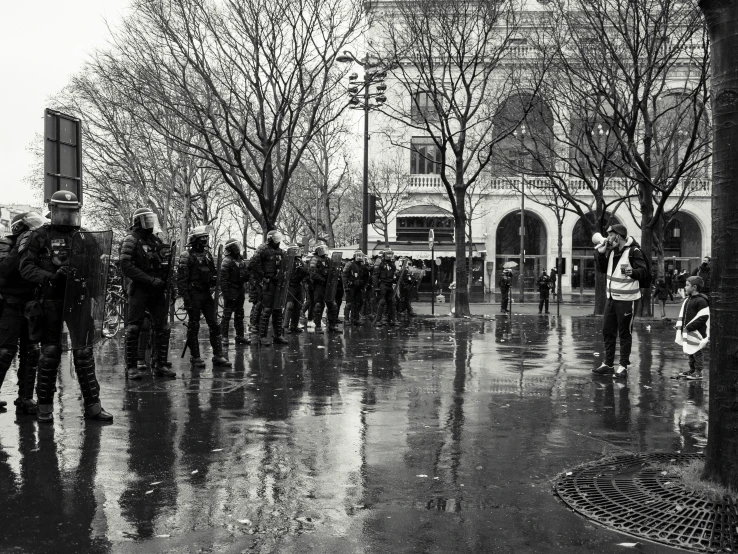 several people walking on the street in the rain