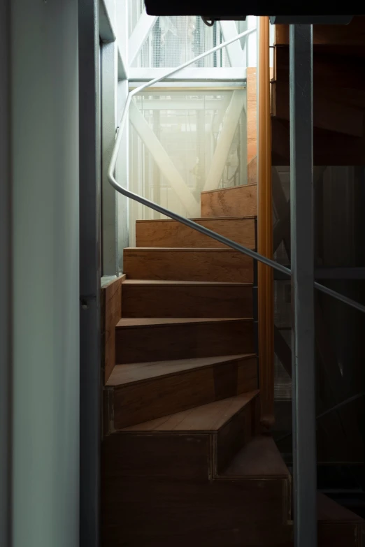 the light is shining on stairs with wooden steps