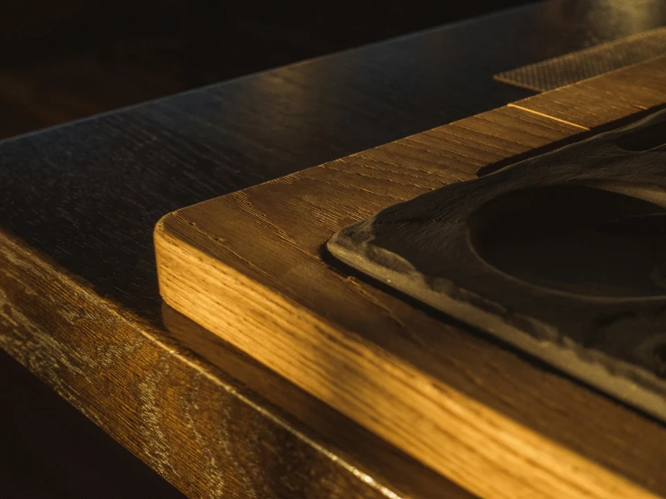 an empty napkin next to an empty cup on top of a wooden surface