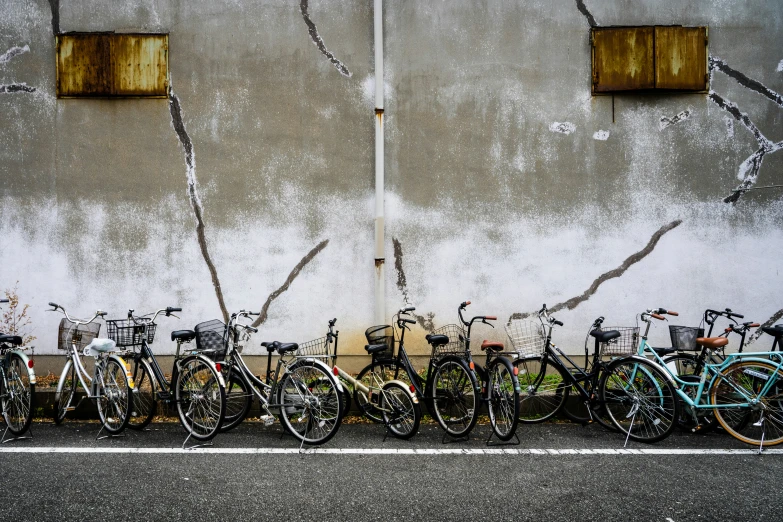 bikes are parked in front of a wall