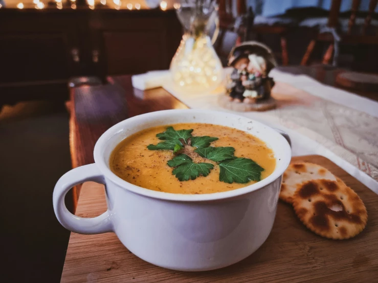 this is a white bowl of soup with bread