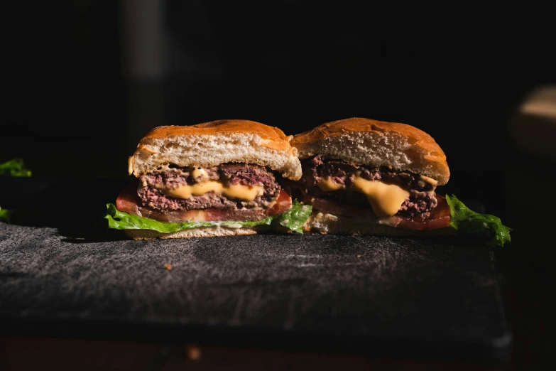 the burger with cheese is sitting on the counter