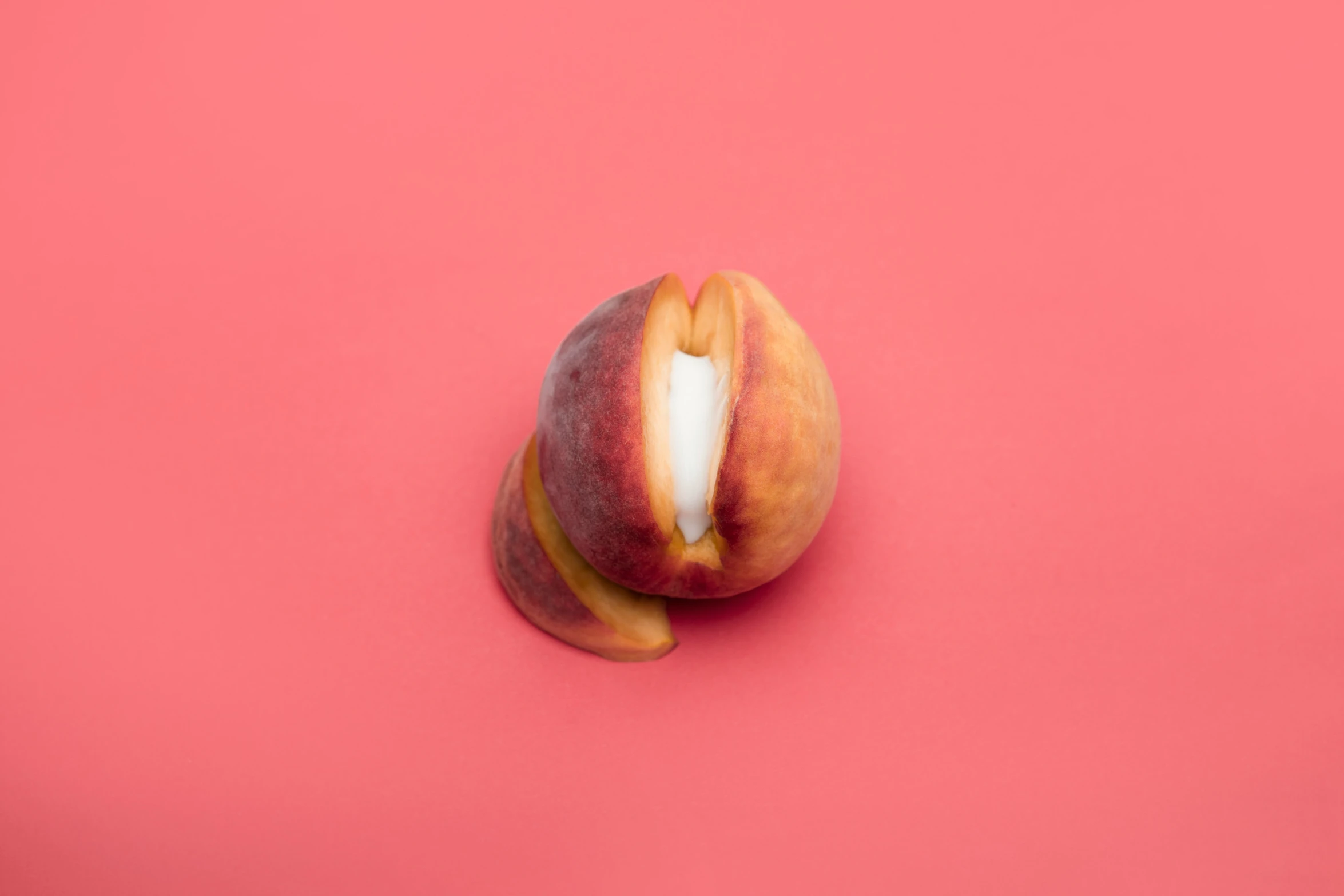 a ripe peach with one slice taken out