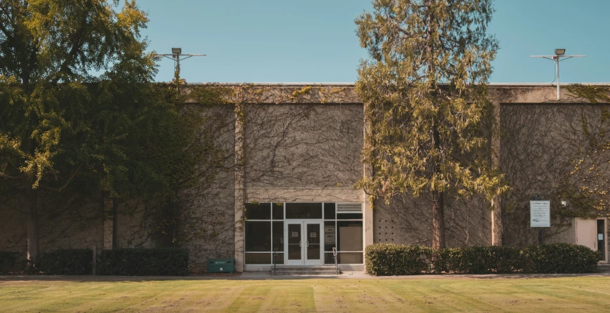 the exterior of a building with many trees