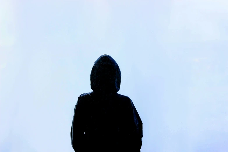 a person in black hoodie looking towards the sky
