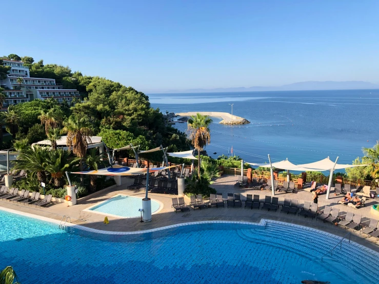 a large swimming pool surrounded by beach chairs