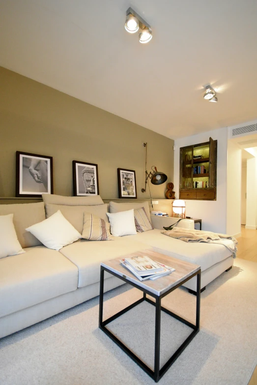 the white couch is in a very well decorated living room