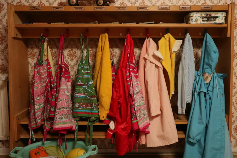 colorful towels and purses hang in a wardrobe