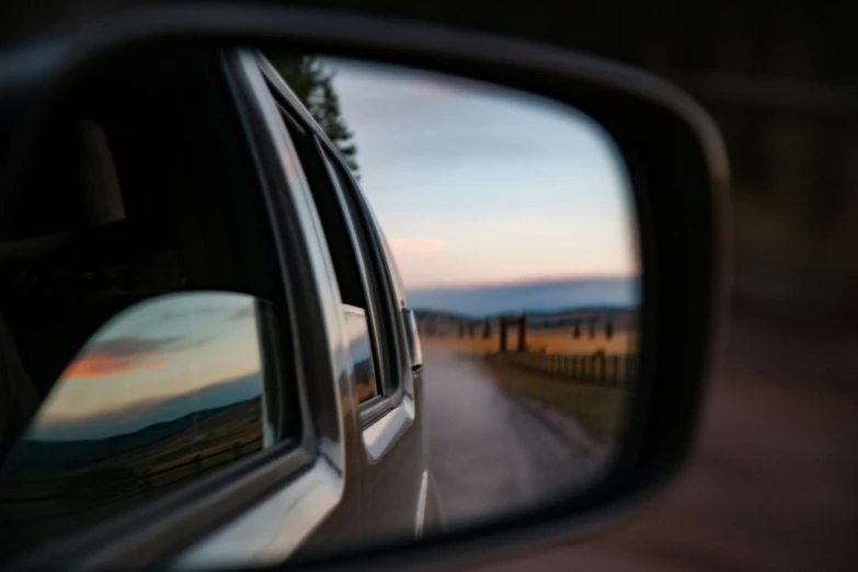 the reflection of an auto in side view mirror