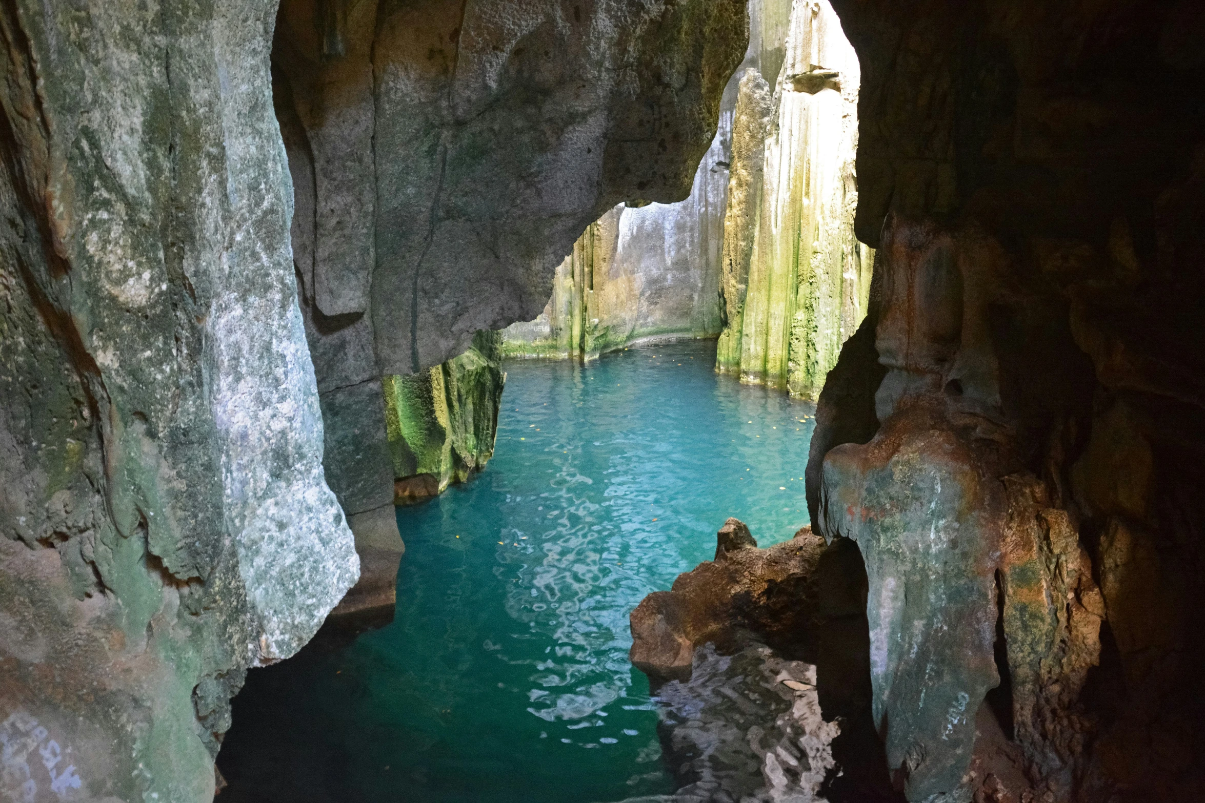 there is a pool in the middle of two cliffs