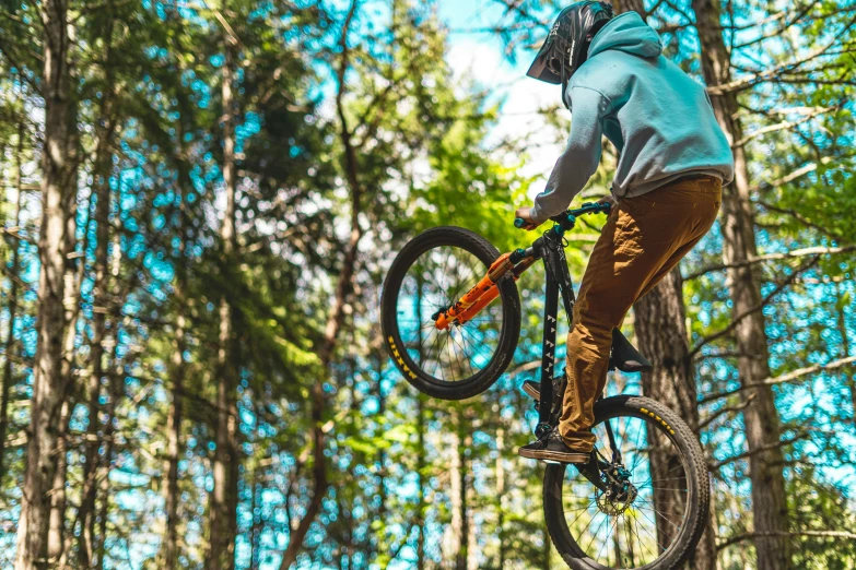 a man flying through the air while riding a bike