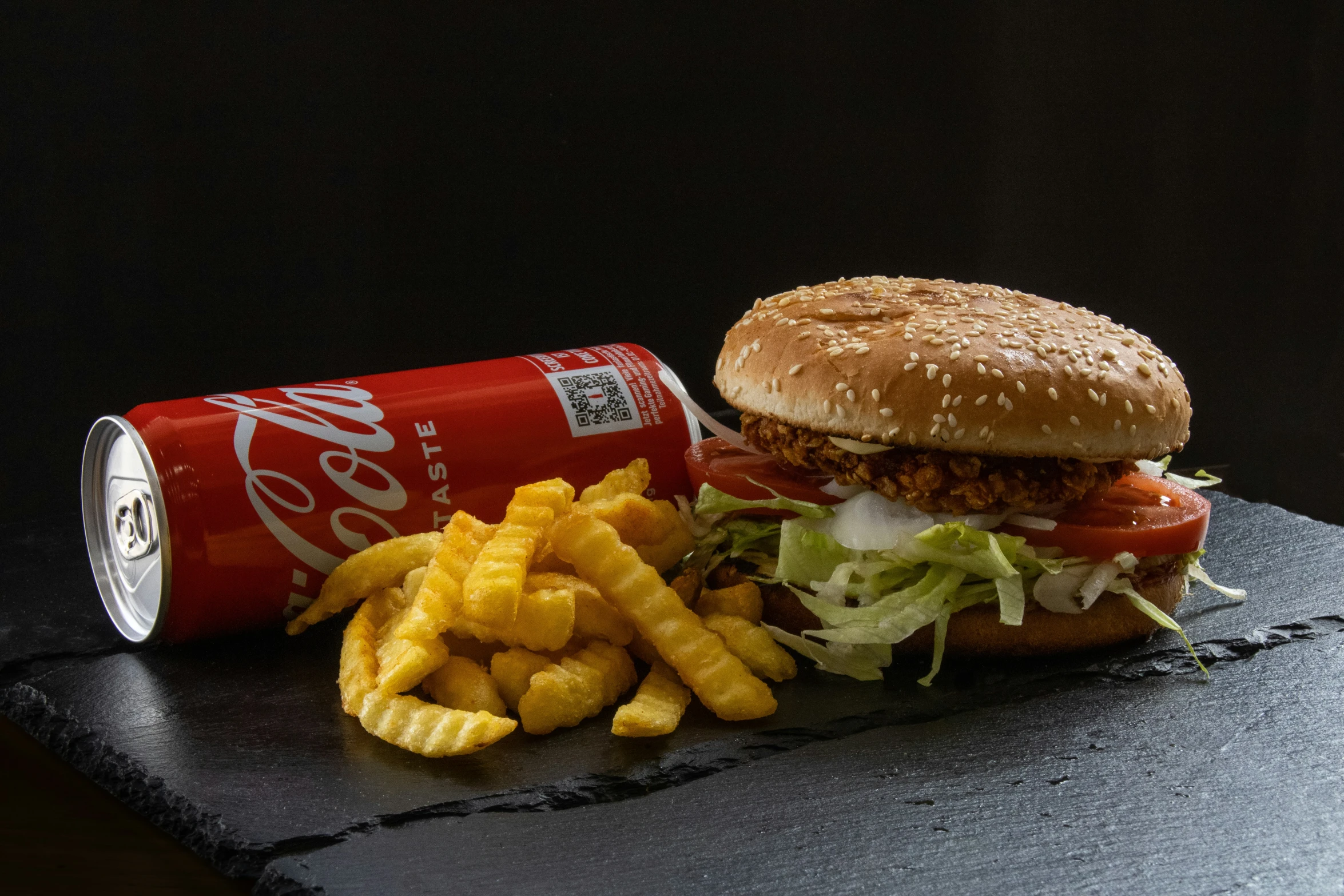 burger, french fries and soda are shown on a counter